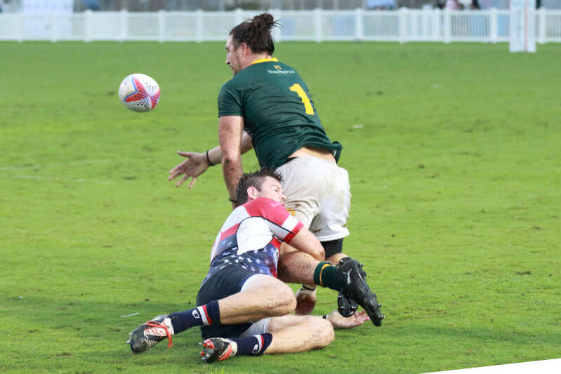 Sam Barton offloading the ball while being tackled, playing for the Classic Springboks against the USA Eagles.